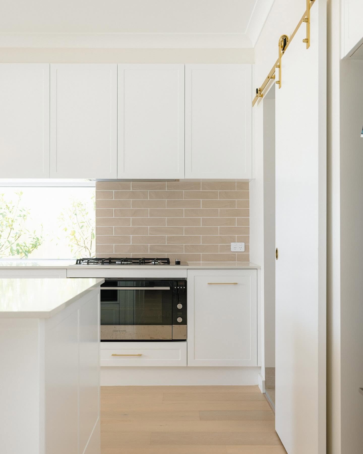Kitchen detail with blush subway tile splashback and gas cooktop