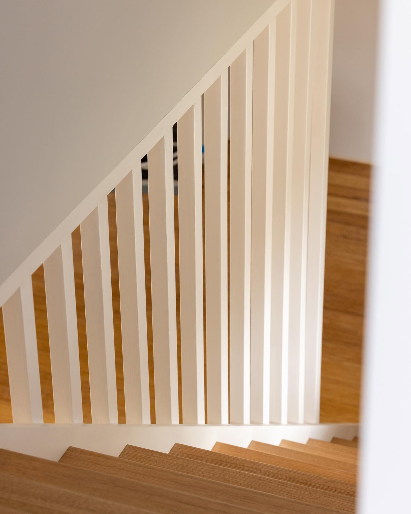 Painted timber balustrade above oak stair treads in a second storey addition