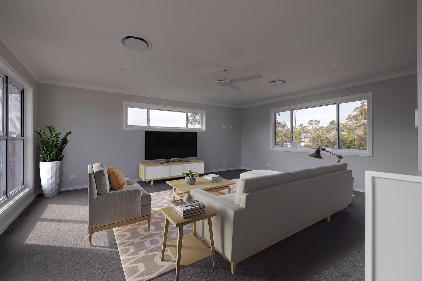 Upstairs living room with wide windows and soft grey finishes