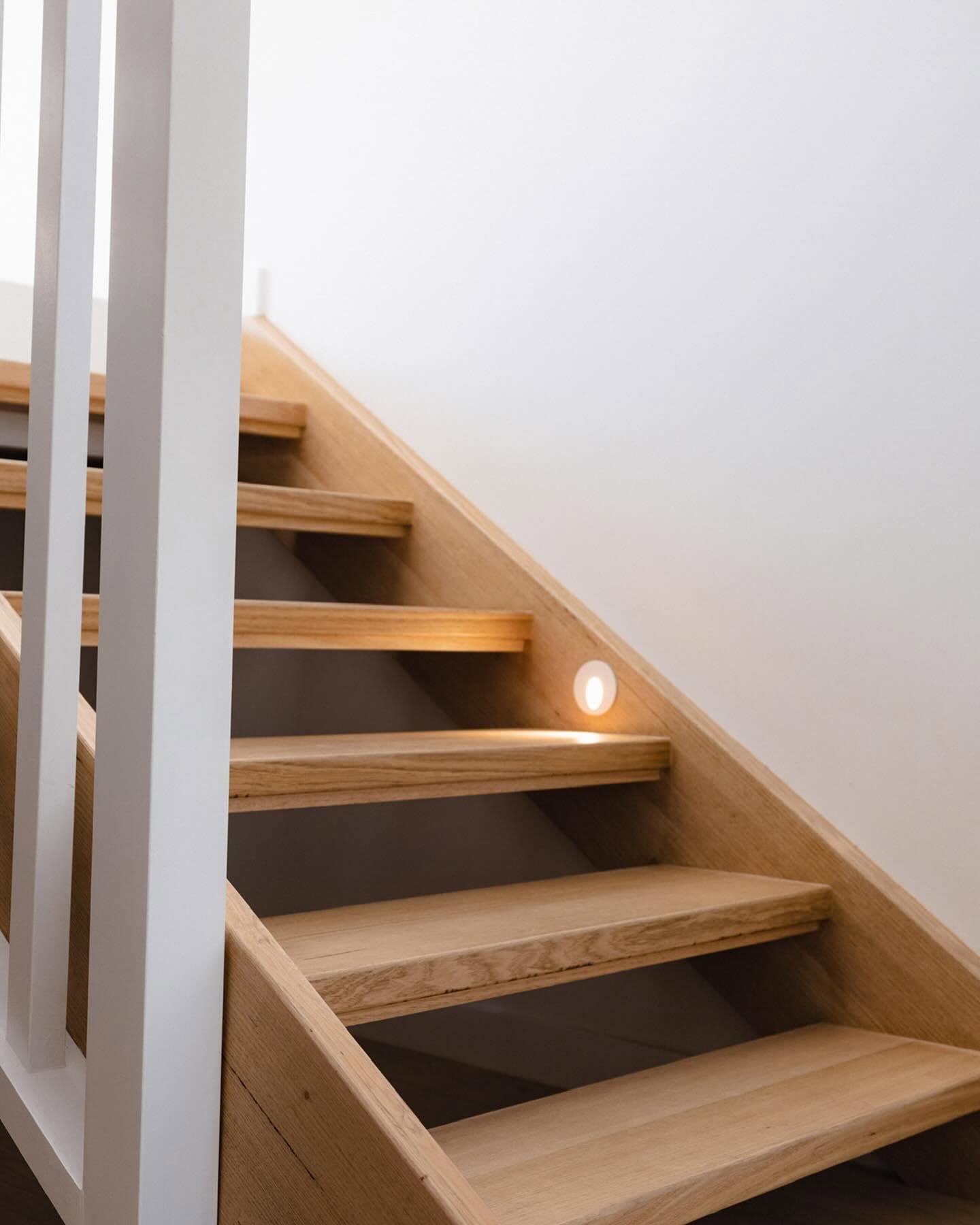 Oak staircase with recessed step lighting in a second storey addition